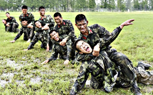 Paramilitary policemen react as they take part in a combat skills training session at a military base in Chaohu...Paramilitary policemen react as they take part in a combat skills training session at a military base in Chaohu, Anhui province, China, June 25, 2015. REUTERS/China Daily CHINA OUT. NO COMMERCIAL OR EDITORIAL SALES IN CHINA